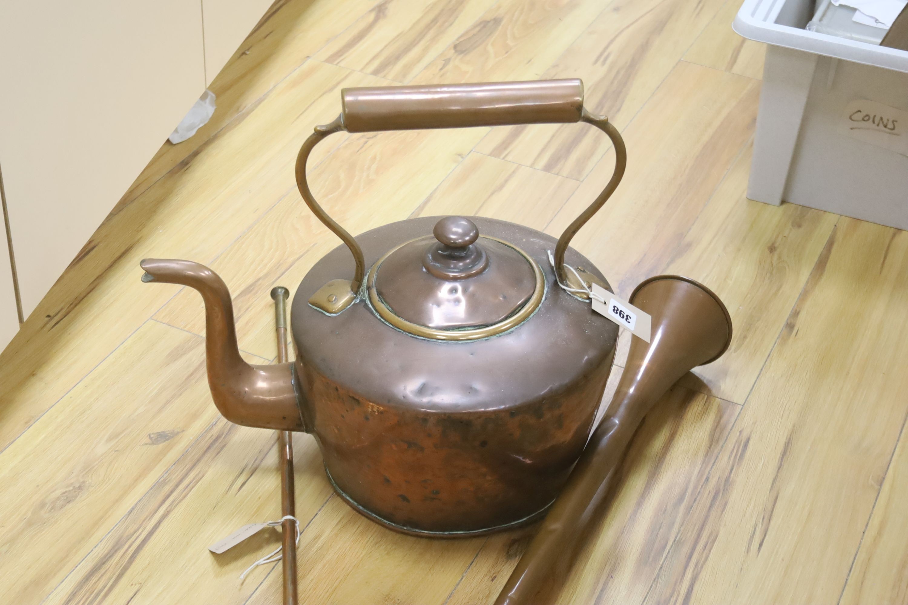 A large Victorian copper kettle with cover, 43cm including handle, and two copper hunting horns